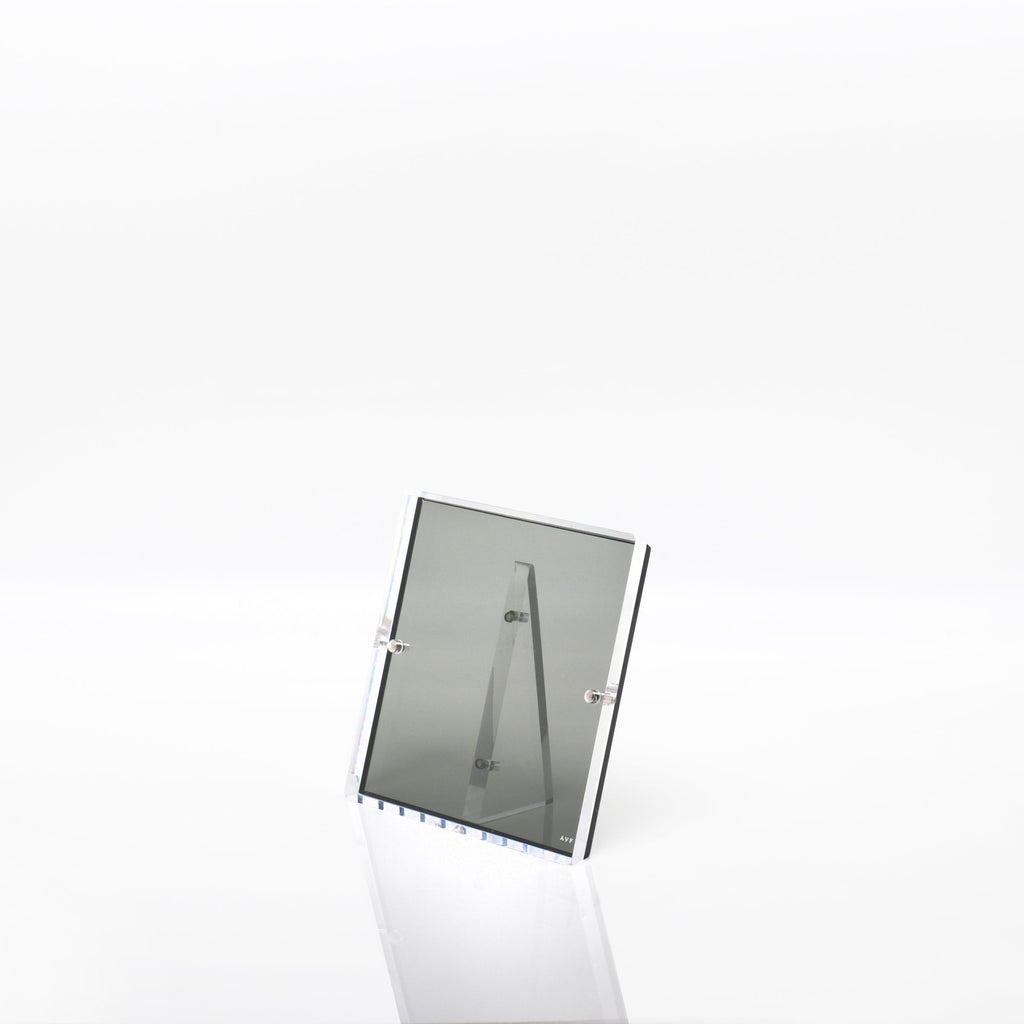 Minimalist rectangular mirror against a plain white background, reflecting nothing.