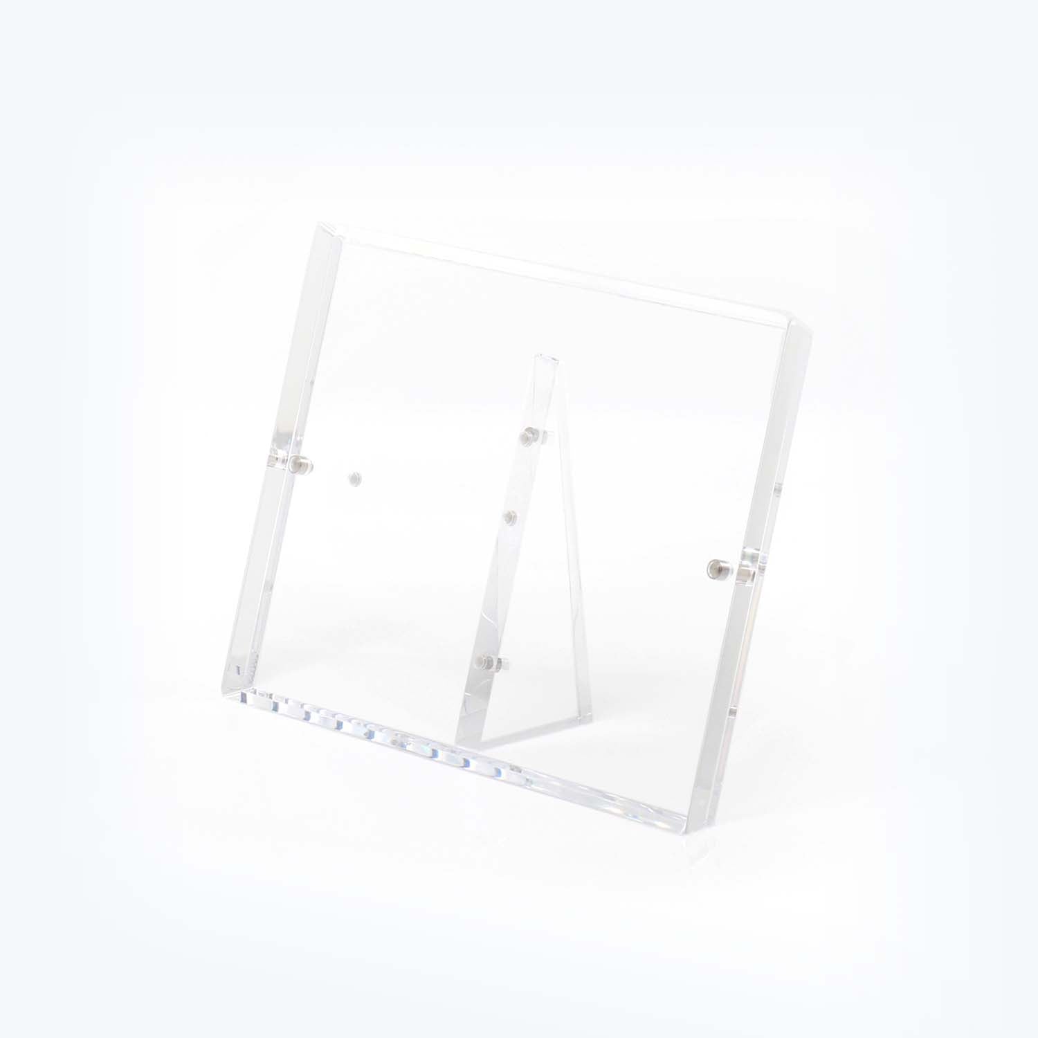 Minimalist clear acrylic stand showcases items with elegance and versatility.