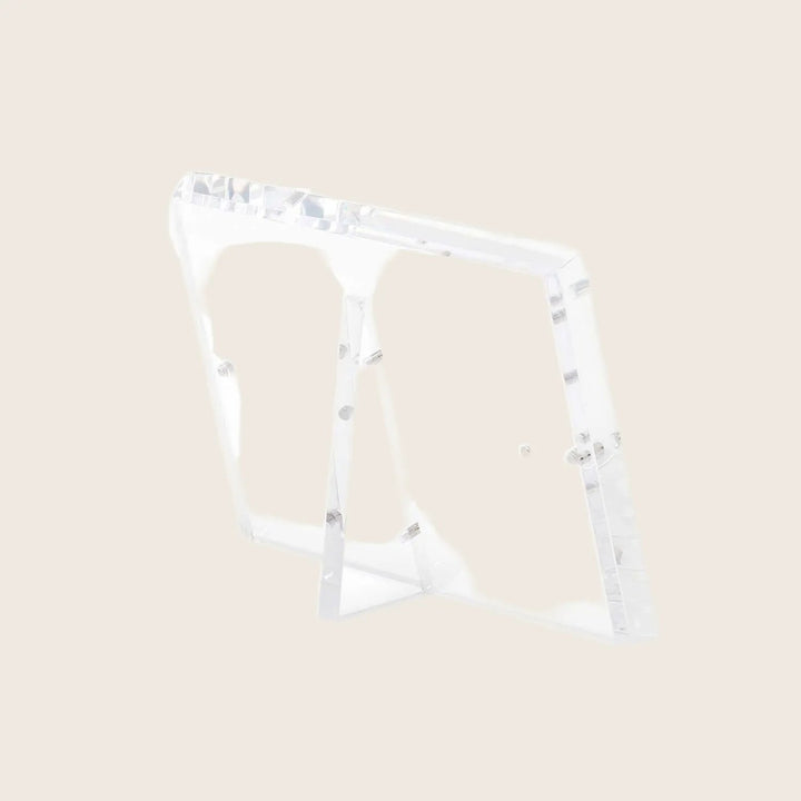 A modern, minimalist acrylic easel with adjustable angle and transparent design.