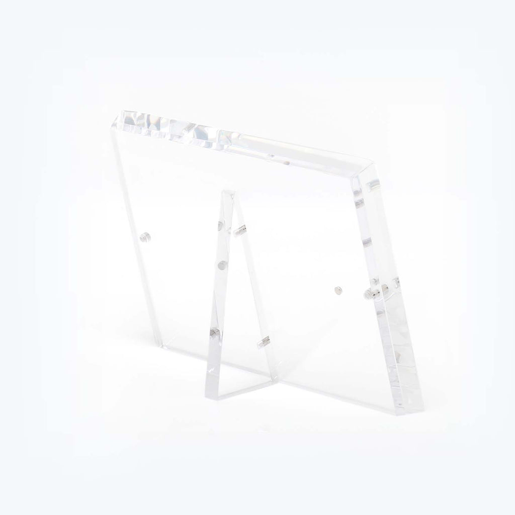 A modern, minimalist acrylic easel with adjustable angle and transparent design.