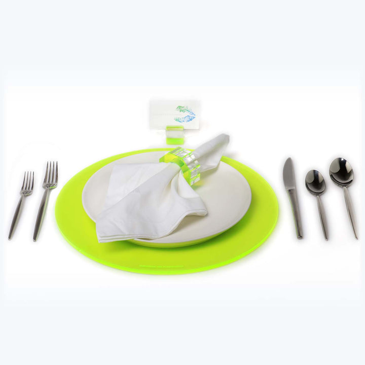 Formally set dining place with bright lime green placemat.