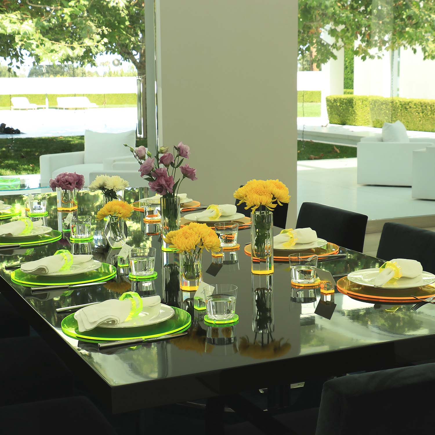 Elegantly set dining table in a sunlit room exudes sophistication.