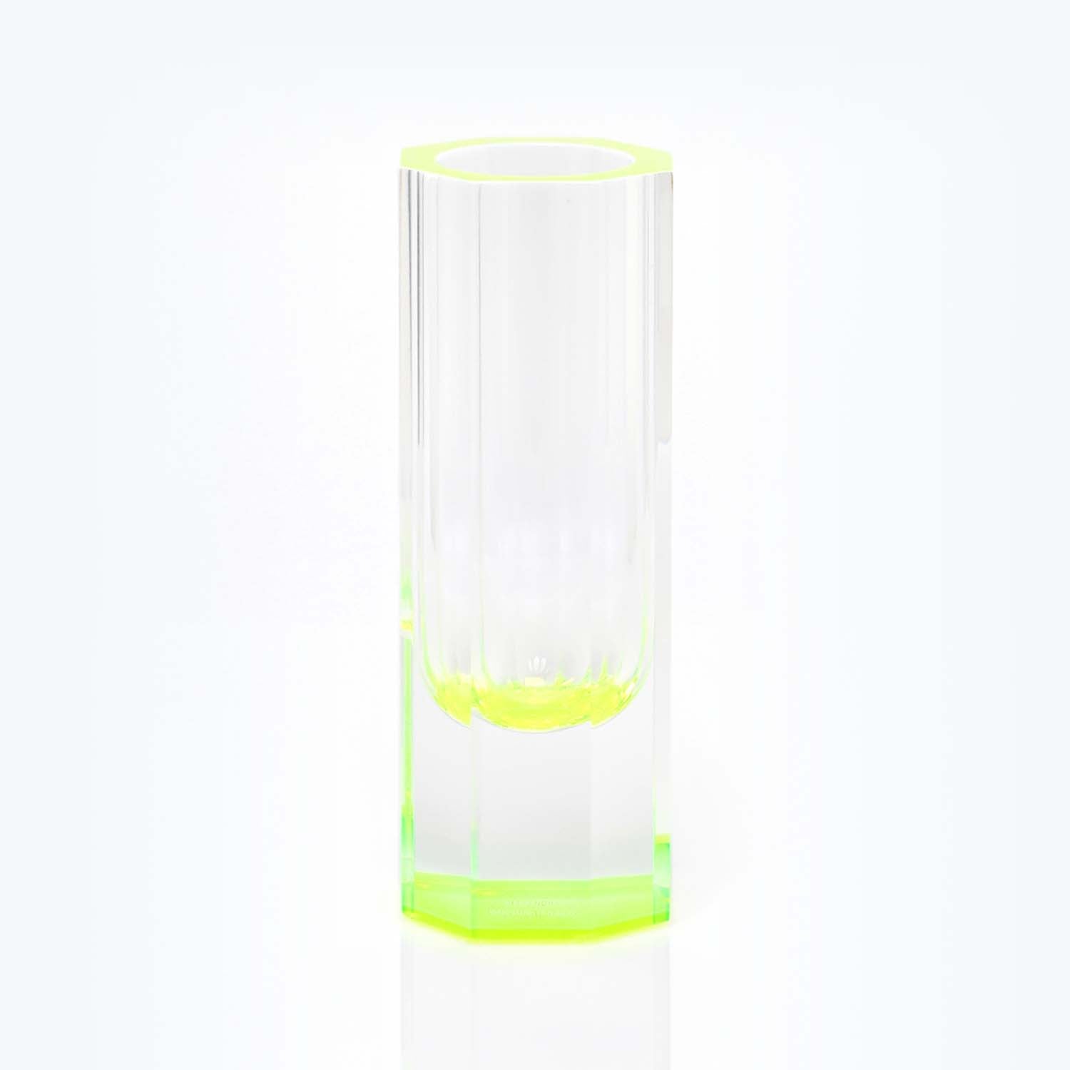 A transparent green-tinted glass showcasing its sleek cylindrical design.