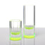 Two modern cylindrical glass vessels with a vibrant green glow.