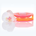 Transparent acrylic tray with orchid flower creates elegant display.