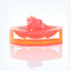 Translucent orange-tinted decorative object with pink crystal-like structures, by Diane von Furstenberg.