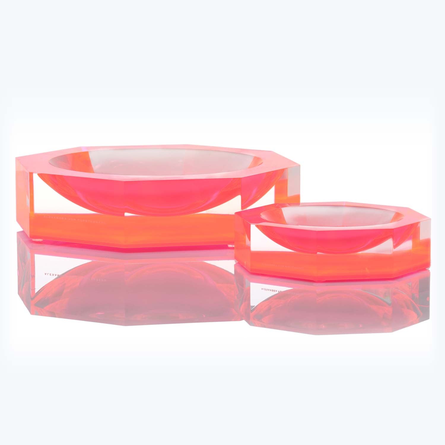 Modern, minimalist red-tinted acrylic decor pieces with glossy reflections.