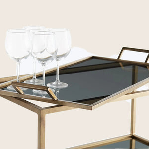 Elegant bar cart with gold frame and glass shelves. - hover