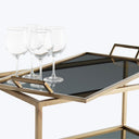 Elegant black serving tray adorned with three pristine wine glasses.