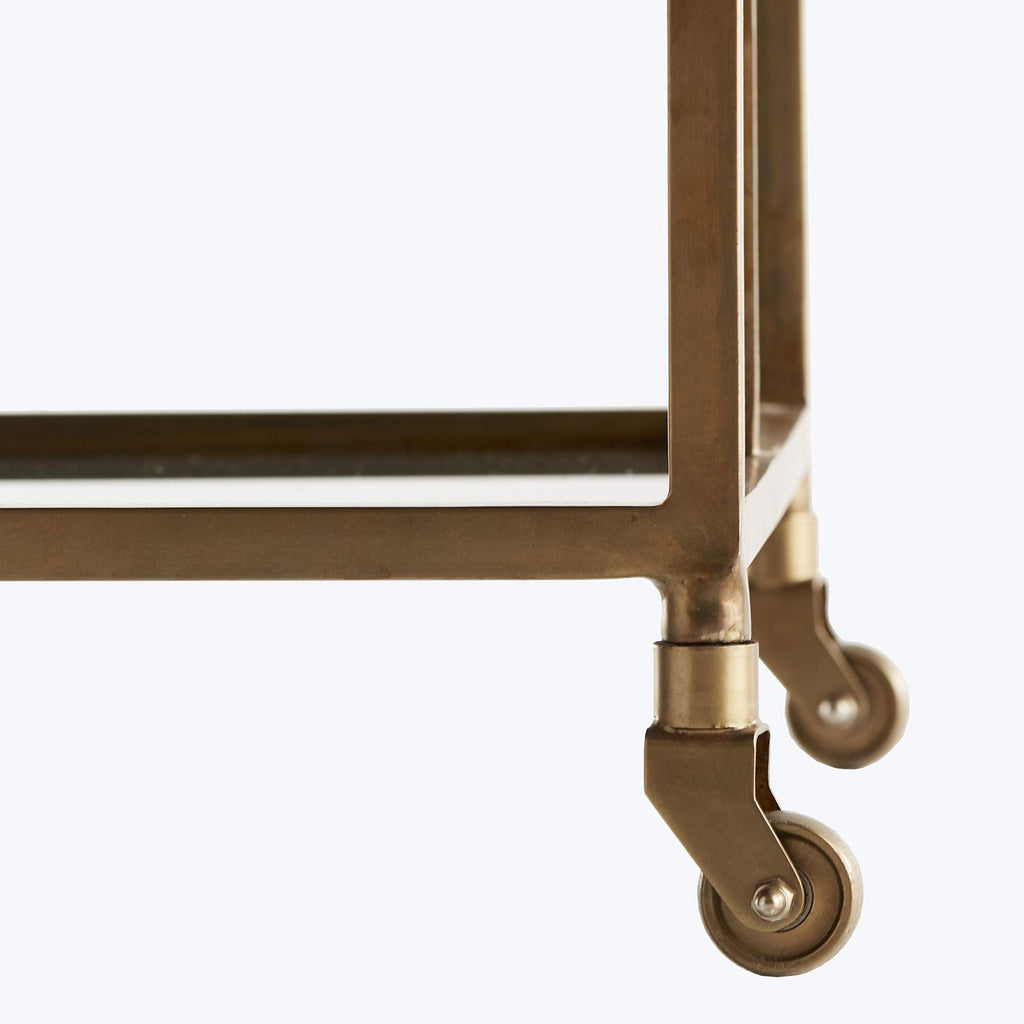 A classic brass table with elegant caster wheels for easy mobility.