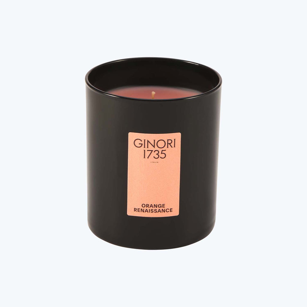 Black jar scented candle with orange renaissance fragrance label.