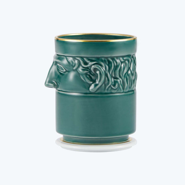 Teal ceramic tumbler with a stylized classical face design.