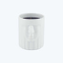 Minimalist cylindrical candle holder with a relief of a human face.