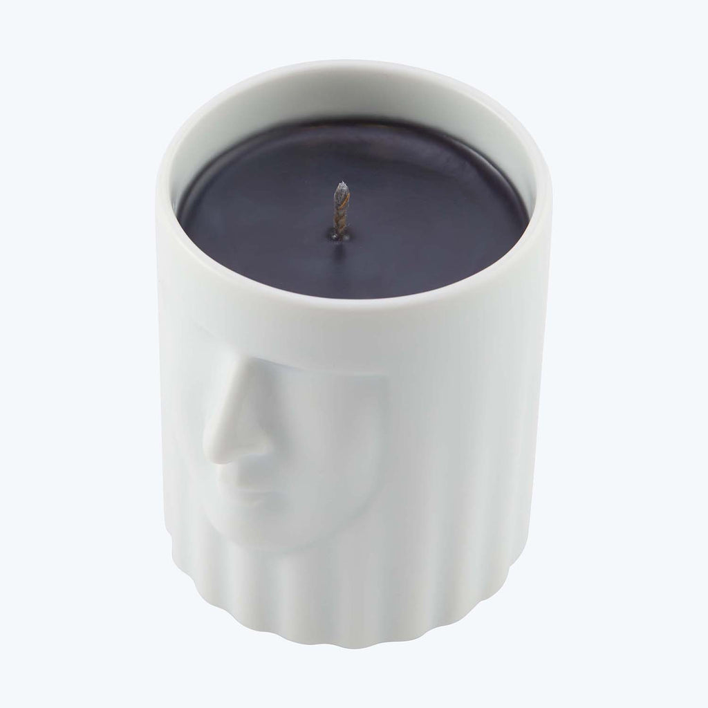 Unique cylindrical candle with a cameo design and contrasting colors.