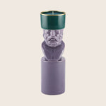 Unique candle holder with sculpted bust design in vibrant colors.