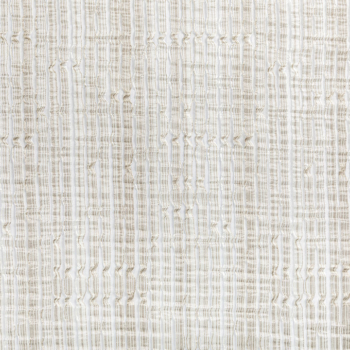 Close-up view of a beige fabric with intricate woven pattern.