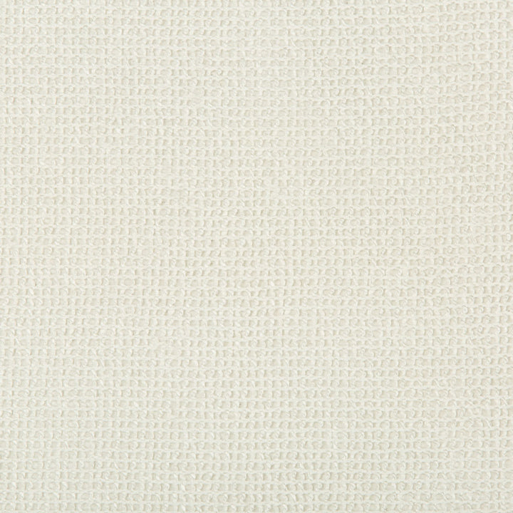 Close-up view of a cream fabric with woven textured pattern.