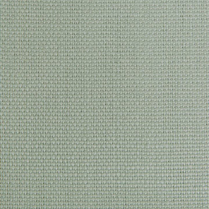 Close-up of muted green fabric with raised diamond-shaped pattern.