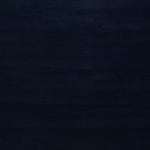 Abstract, dark composition with textured black strokes in low-light environment.