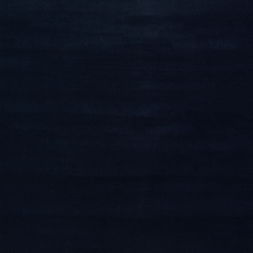 Abstract, dark composition with textured black strokes in low-light environment.