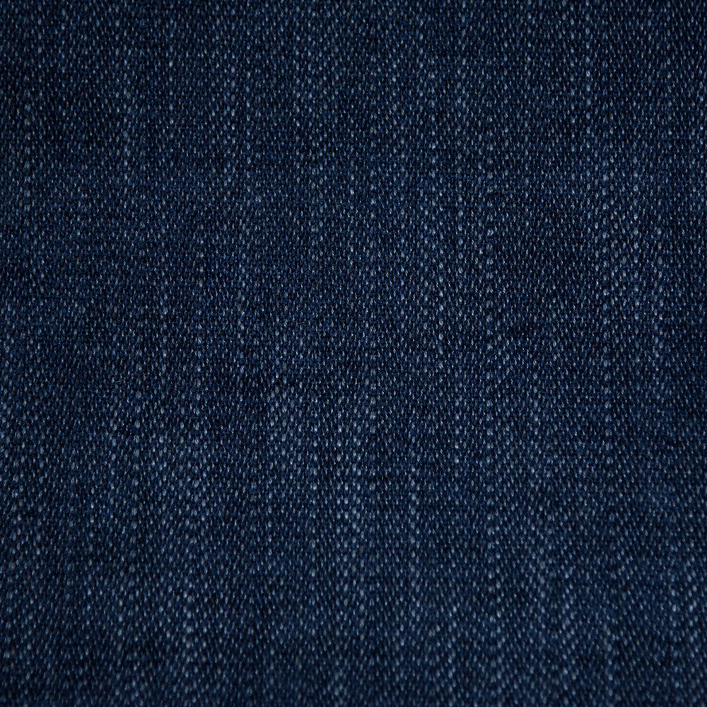 Close-up of a textured denim fabric with diagonal weave pattern.