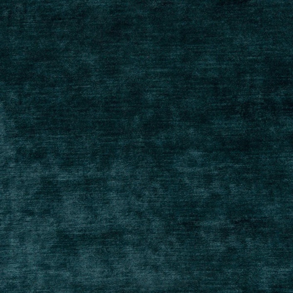 Close-up of distressed dark teal fabric with plush velvet texture