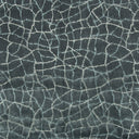 Close-up view of a cracked fabric texture in blue hues
