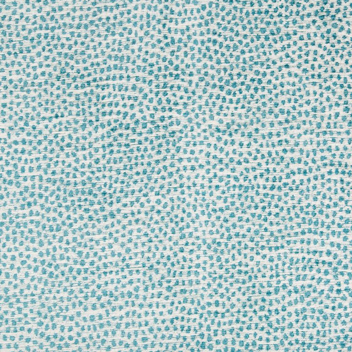 Close-up of teal dotted fabric with organic, speckled texture.