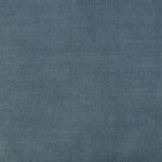 Close-up of medium blue denim fabric with twill weave texture.