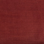 Close-up of a luxurious maroon fabric with woven texture.