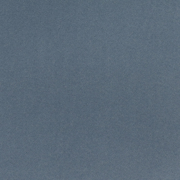 Close-up of blue denim fabric with diagonal ribbing pattern.