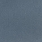 Close-up of blue denim fabric with diagonal ribbing pattern.