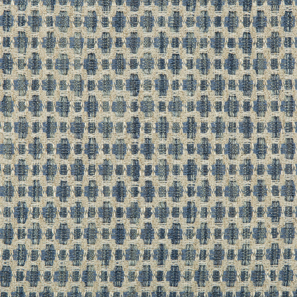 Close-up of a textured fabric with frayed blue square figures.