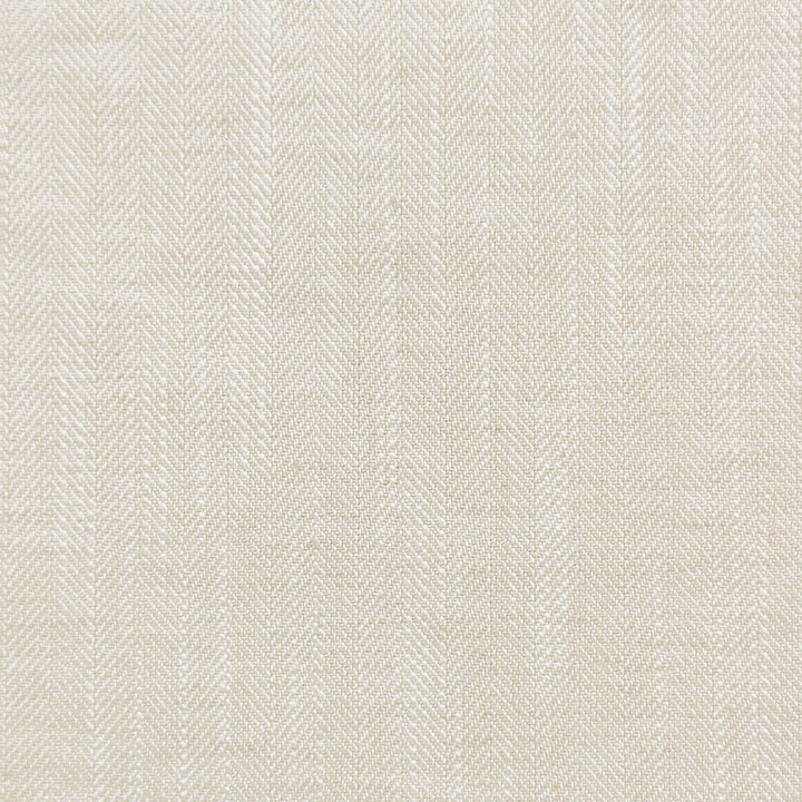 Close-up of textured twill weave fabric in light neutral tone.