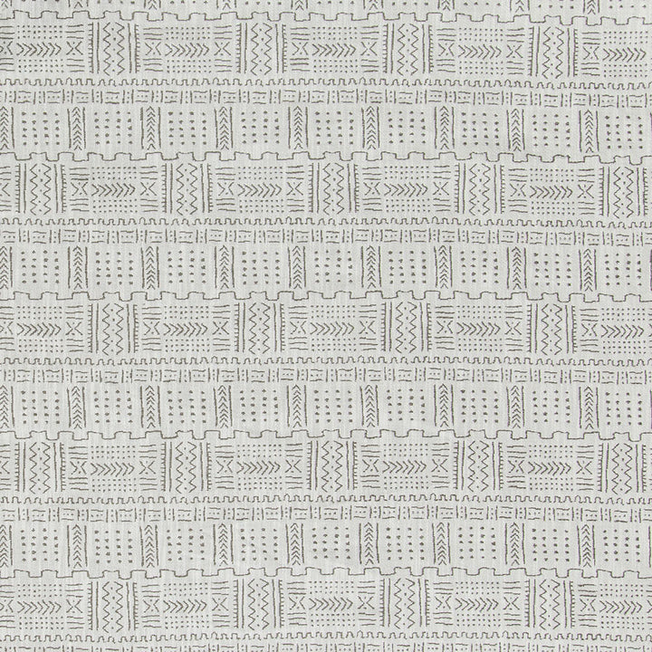 Textured fabric with tribal-inspired geometric pattern in contrasting stitches.