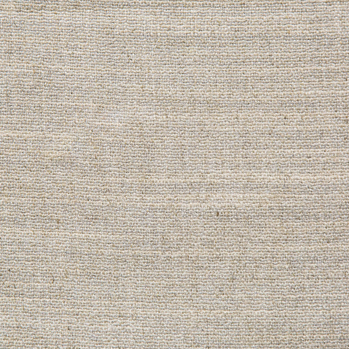 Close-up of a beige woven fabric with coarse texture and crisscross pattern.