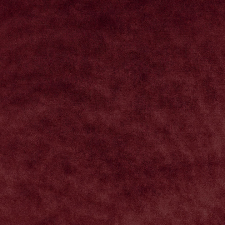 Close-up of plush burgundy fabric with velvety texture and variations.