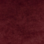 Close-up of plush burgundy fabric with velvety texture and variations.