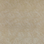 Close-up of a creamy beige fabric with mottled texture.