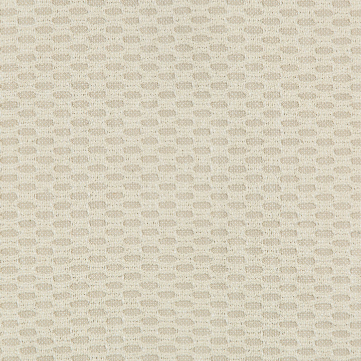 Close-up of textured fabric with woven oval-like patterns in neutral beige.