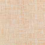 Close-up of a textured fabric with a warm, grid-like pattern.