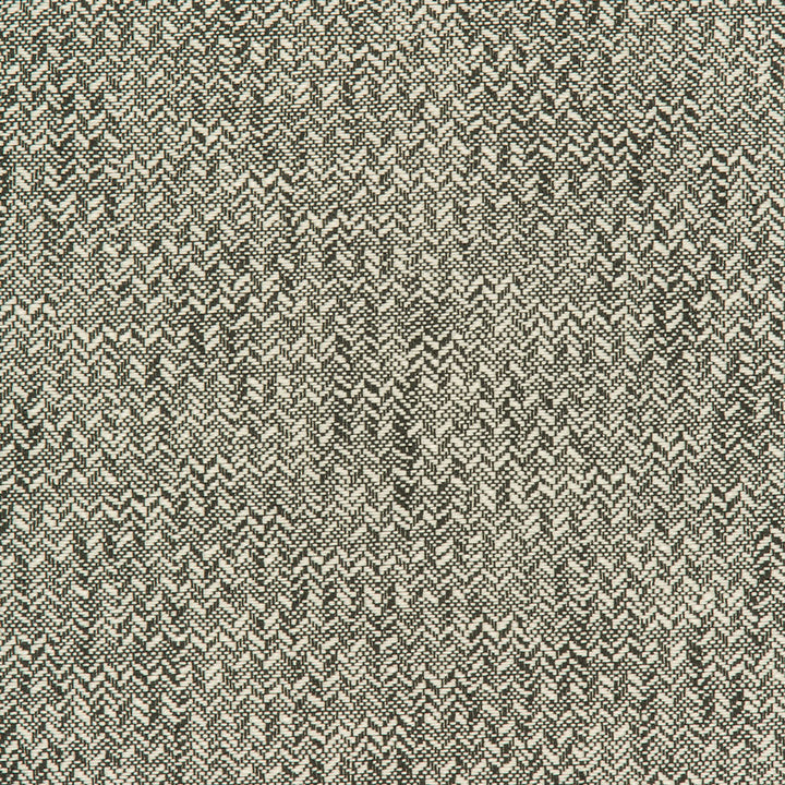 Close-up of herringbone pattern fabric with contrasting light and dark threads.