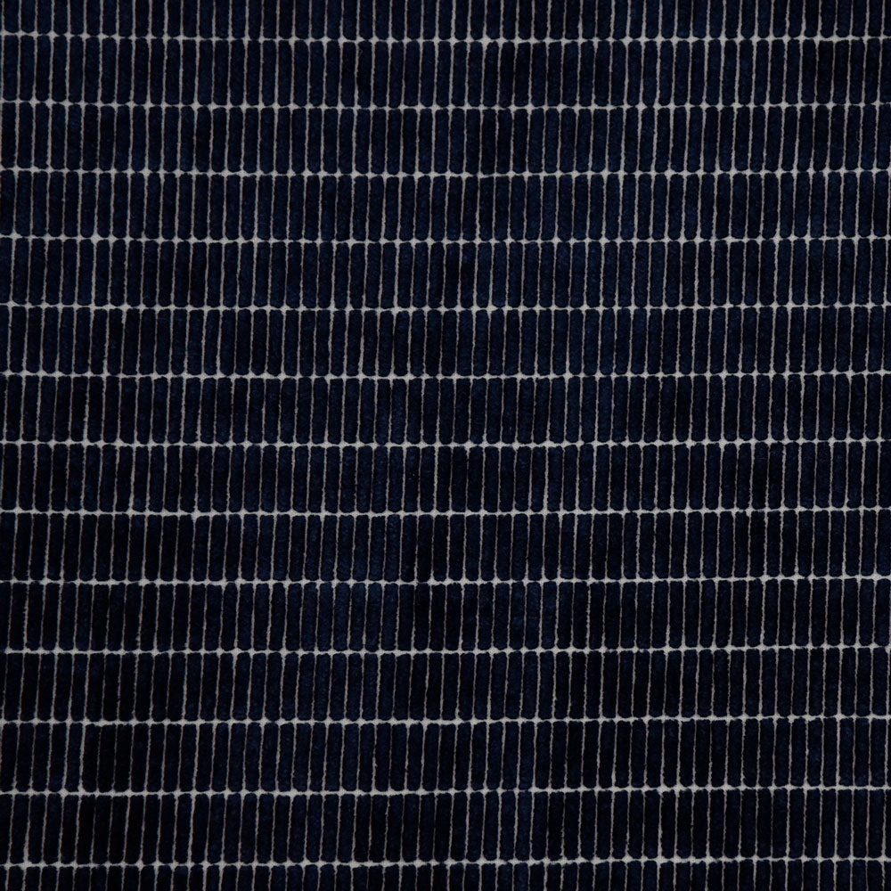 Close-up of denim fabric, showcasing twill weave and ribbing effect.