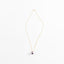Elegant gold necklace with purple pearl pendant on white background.