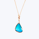 Exquisite teardrop pendant with vibrant blue stone and intricate craftsmanship.