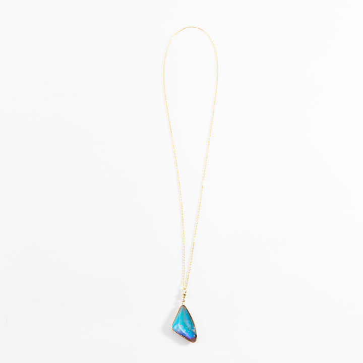 Elegant gold necklace with a stunning blue gemstone pendant
