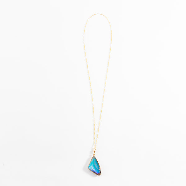 Elegant gold necklace with a stunning blue gemstone pendant