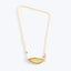 Dainty gold necklace with translucent pendant and delicate bead chain.