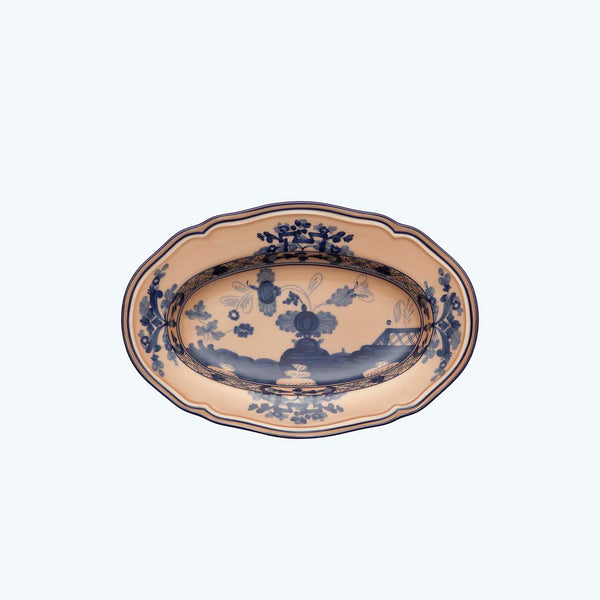 An oval decorative plate with detailed blue floral motifs