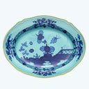 An oval porcelain platter with intricate blue and white Chinese design.